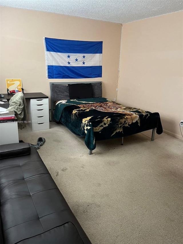 bedroom with carpet flooring and a textured ceiling