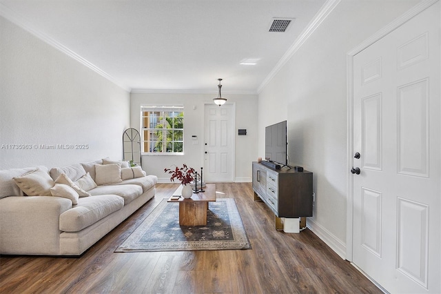 living room with dark hardwood / wood-style flooring and ornamental molding