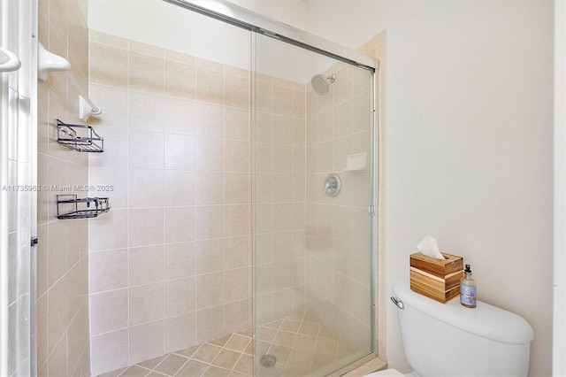 bathroom with toilet and a shower with shower door