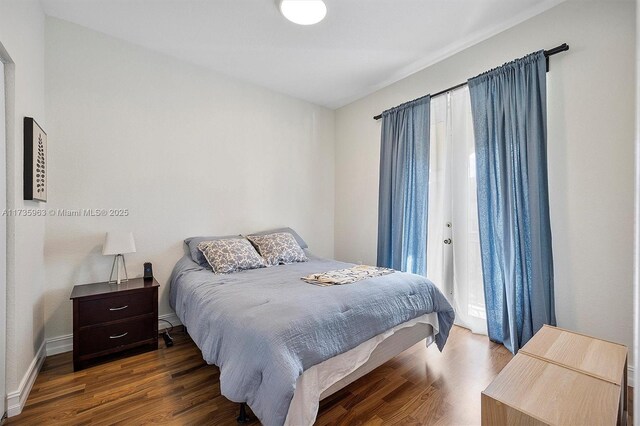 bedroom with dark hardwood / wood-style floors