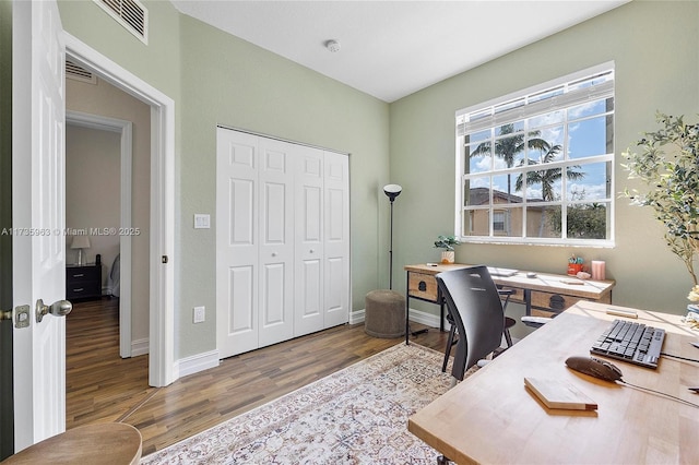 home office with hardwood / wood-style floors