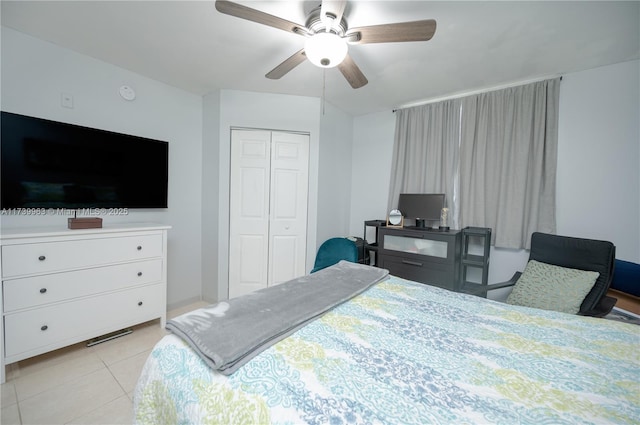 bedroom with light tile patterned flooring, ceiling fan, and a closet