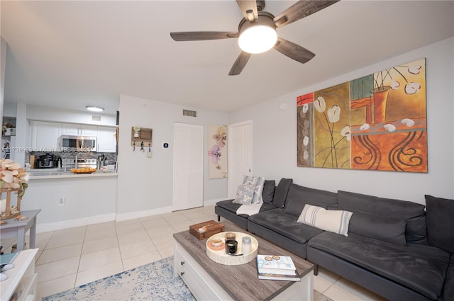 tiled living room with ceiling fan