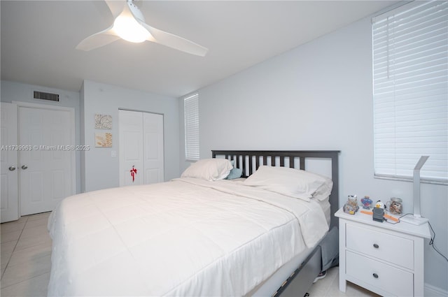 bedroom featuring a closet, ceiling fan, and light tile patterned flooring