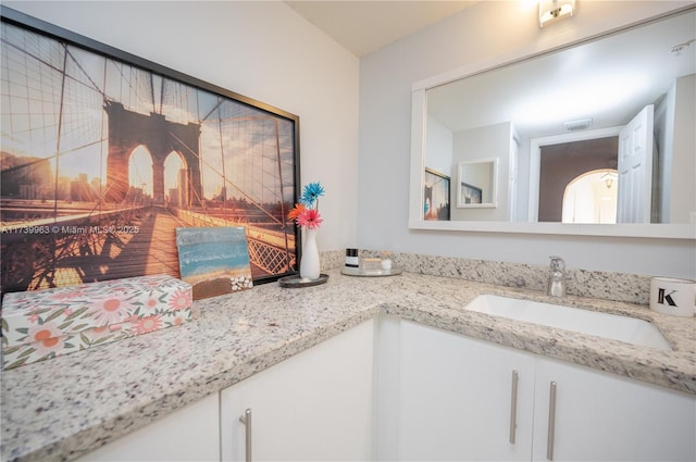 bathroom featuring vanity and a fireplace