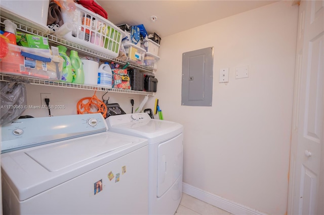 clothes washing area featuring light tile patterned floors, electric panel, and independent washer and dryer