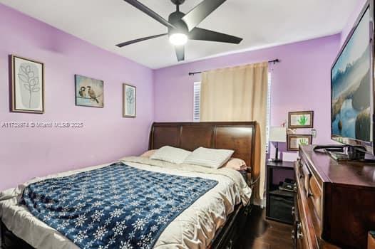 bedroom featuring ceiling fan and dark wood-type flooring