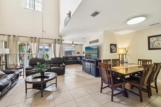 dining area with plenty of natural light, visible vents, and light tile patterned flooring