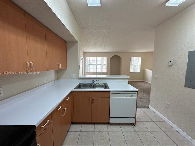 kitchen with sink, light tile patterned floors, electric panel, dishwasher, and kitchen peninsula