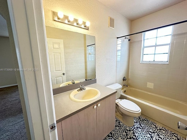 full bathroom with tiled shower / bath combo, vanity, tile patterned floors, and toilet