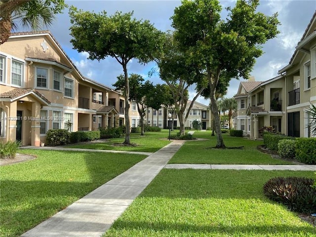 view of property's community with a lawn