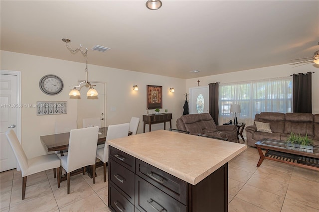 kitchen featuring hanging light fixtures, light tile patterned floors, and a center island