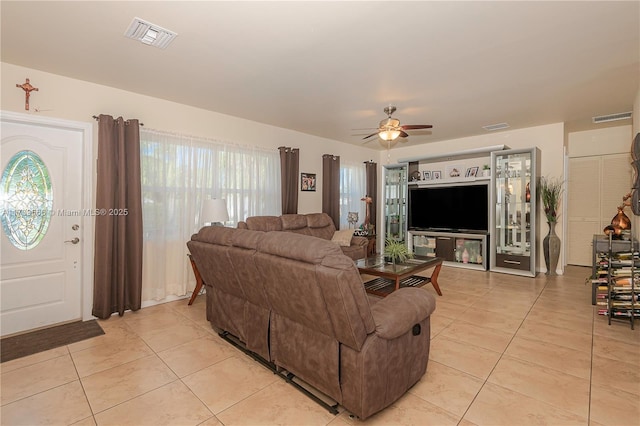 living room with light tile patterned floors and ceiling fan