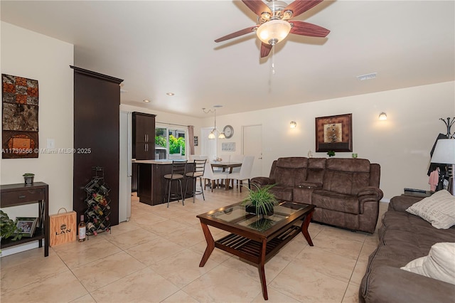 tiled living room with ceiling fan