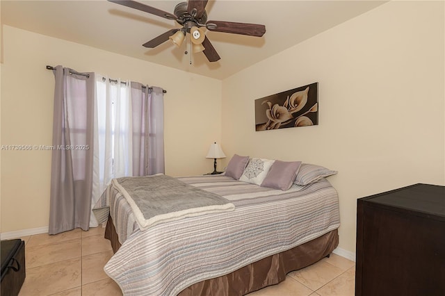 tiled bedroom with ceiling fan