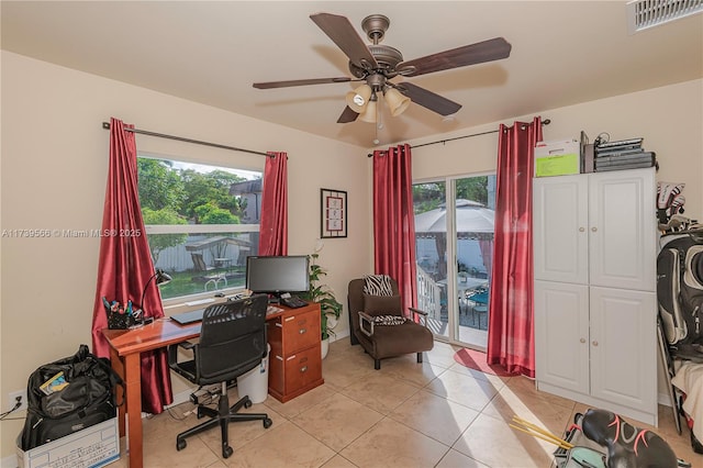 office featuring light tile patterned floors and ceiling fan