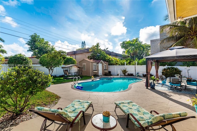 view of pool featuring a gazebo, a patio area, and a storage unit