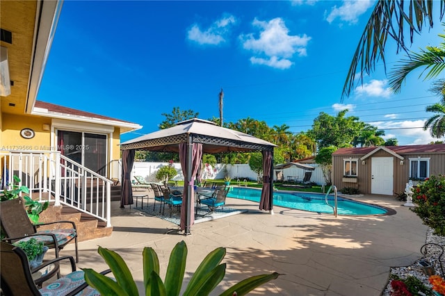 view of pool with a gazebo, a patio area, and a shed