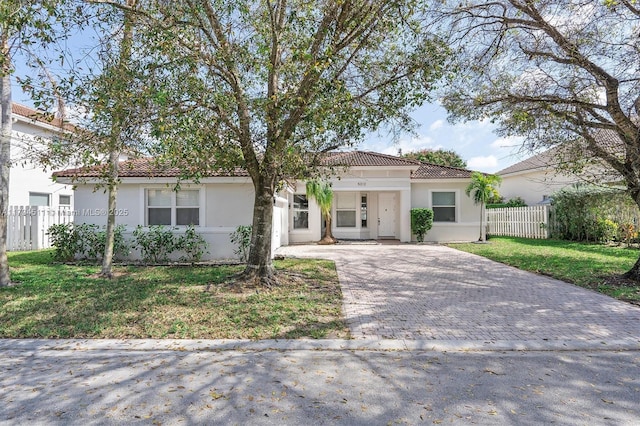 mediterranean / spanish house with a front lawn