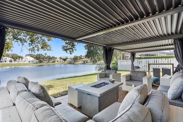 view of patio with an outdoor living space with a fire pit and a water view