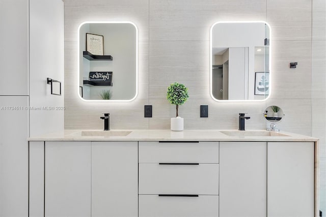 bathroom with vanity, backsplash, and tile walls