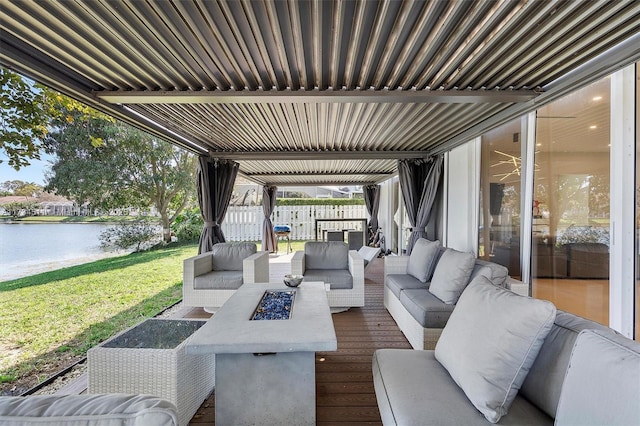 view of patio / terrace with an outdoor living space with a fire pit and a water view