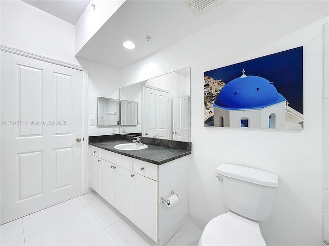 bathroom with vanity, tile patterned flooring, and toilet