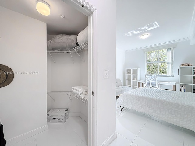 bedroom with light tile patterned floors and ornamental molding