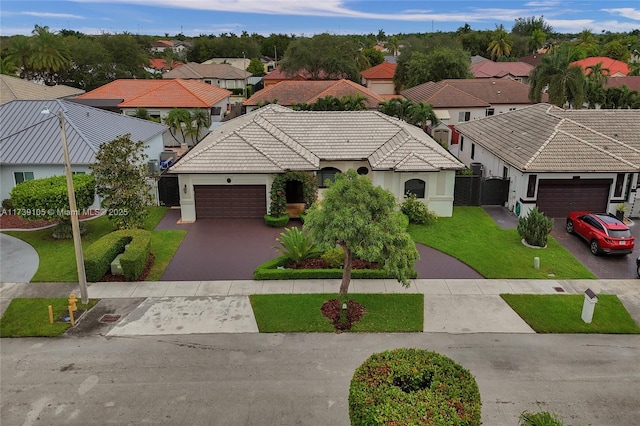 view of front of home with a garage and a front lawn