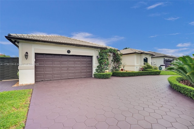 mediterranean / spanish-style home with a garage