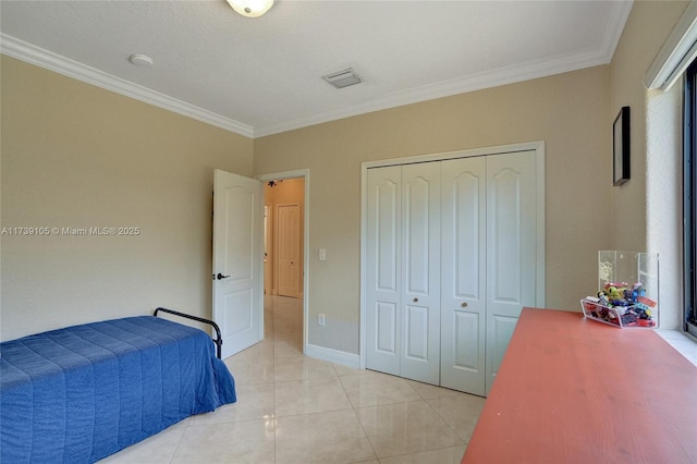 tiled bedroom with crown molding and a closet