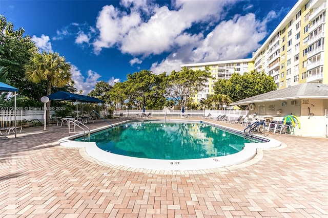 view of swimming pool with a patio area