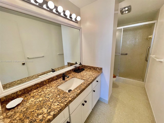 bathroom featuring vanity, a shower with shower door, and toilet