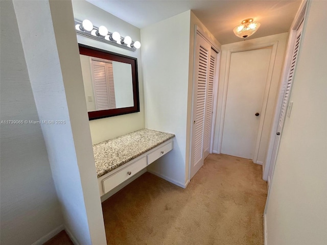 hallway with light colored carpet