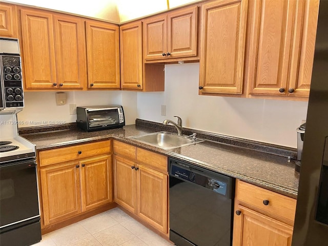 kitchen featuring sink, light tile patterned floors, and black appliances