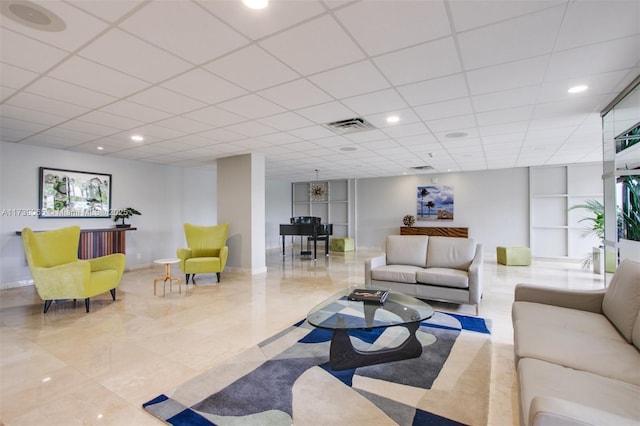 living room featuring a drop ceiling