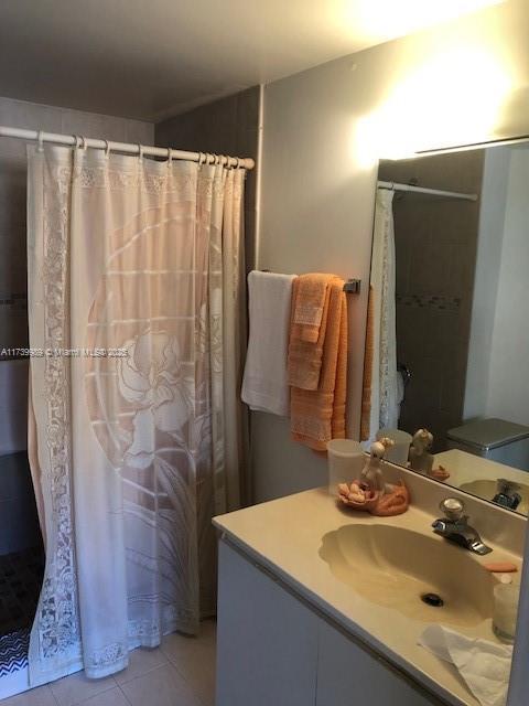 bathroom featuring tile patterned floors, a shower with shower curtain, and vanity