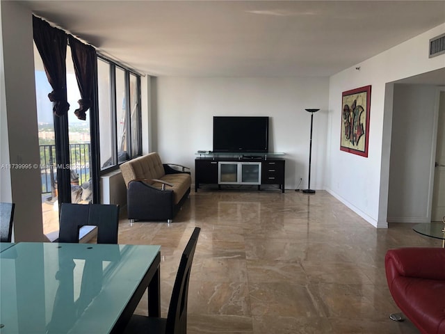 living room featuring a wall of windows