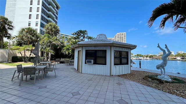 view of patio with a water view and cooling unit