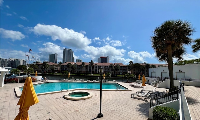 view of pool with a jacuzzi and a patio area