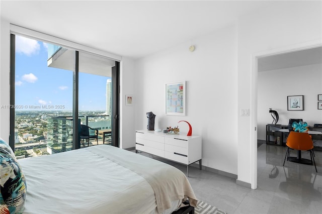 bedroom with expansive windows and access to outside