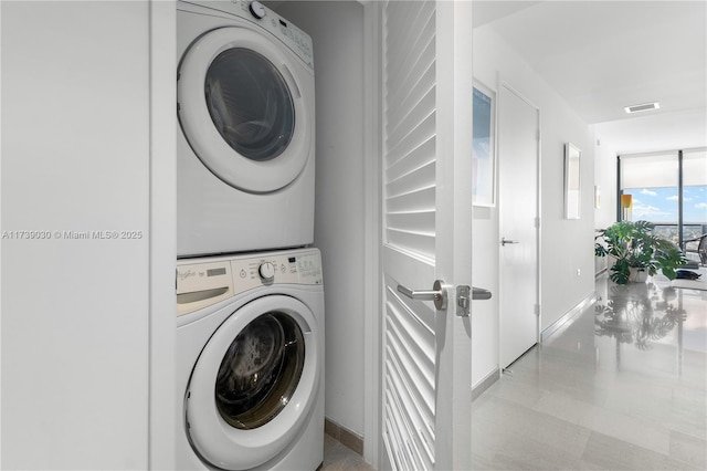 laundry area featuring stacked washer / dryer