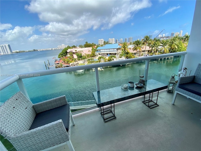 balcony featuring a water view and a city view