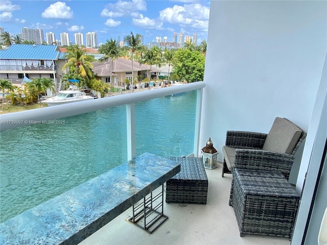 balcony featuring a view of city and a water view