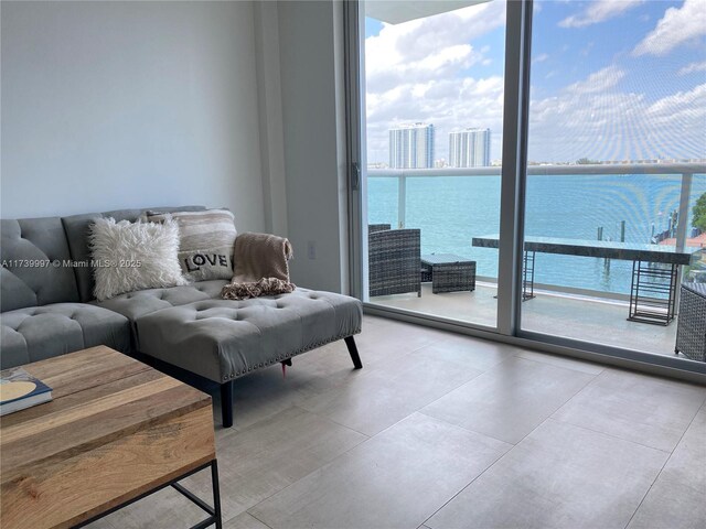 living room with expansive windows and a water view