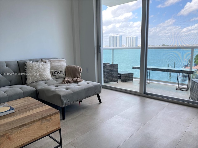 living area featuring expansive windows and a water view