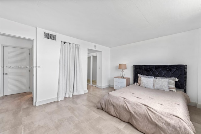 bedroom with baseboards and visible vents