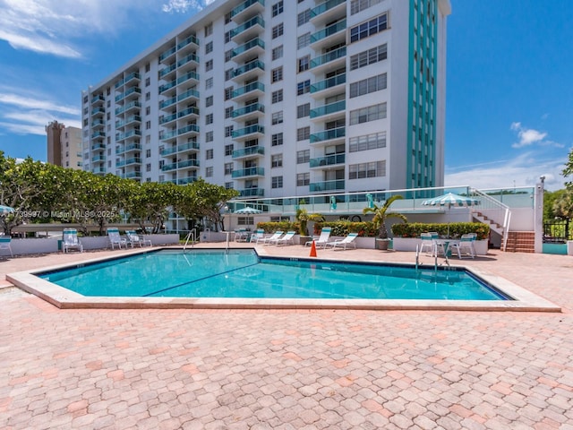 community pool with a patio area