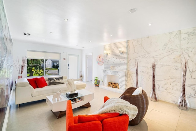 living room featuring light tile patterned floors and a fireplace