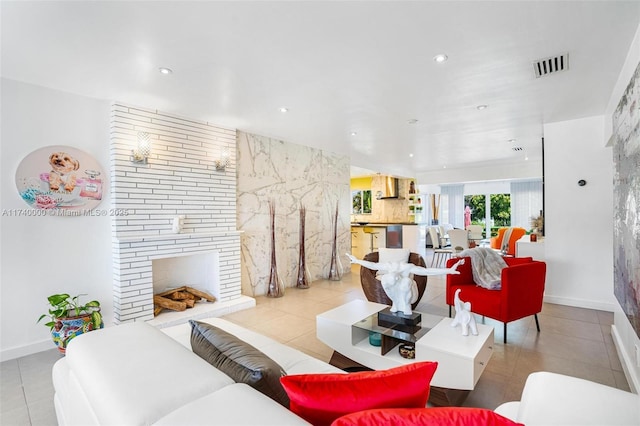 tiled living room with a large fireplace